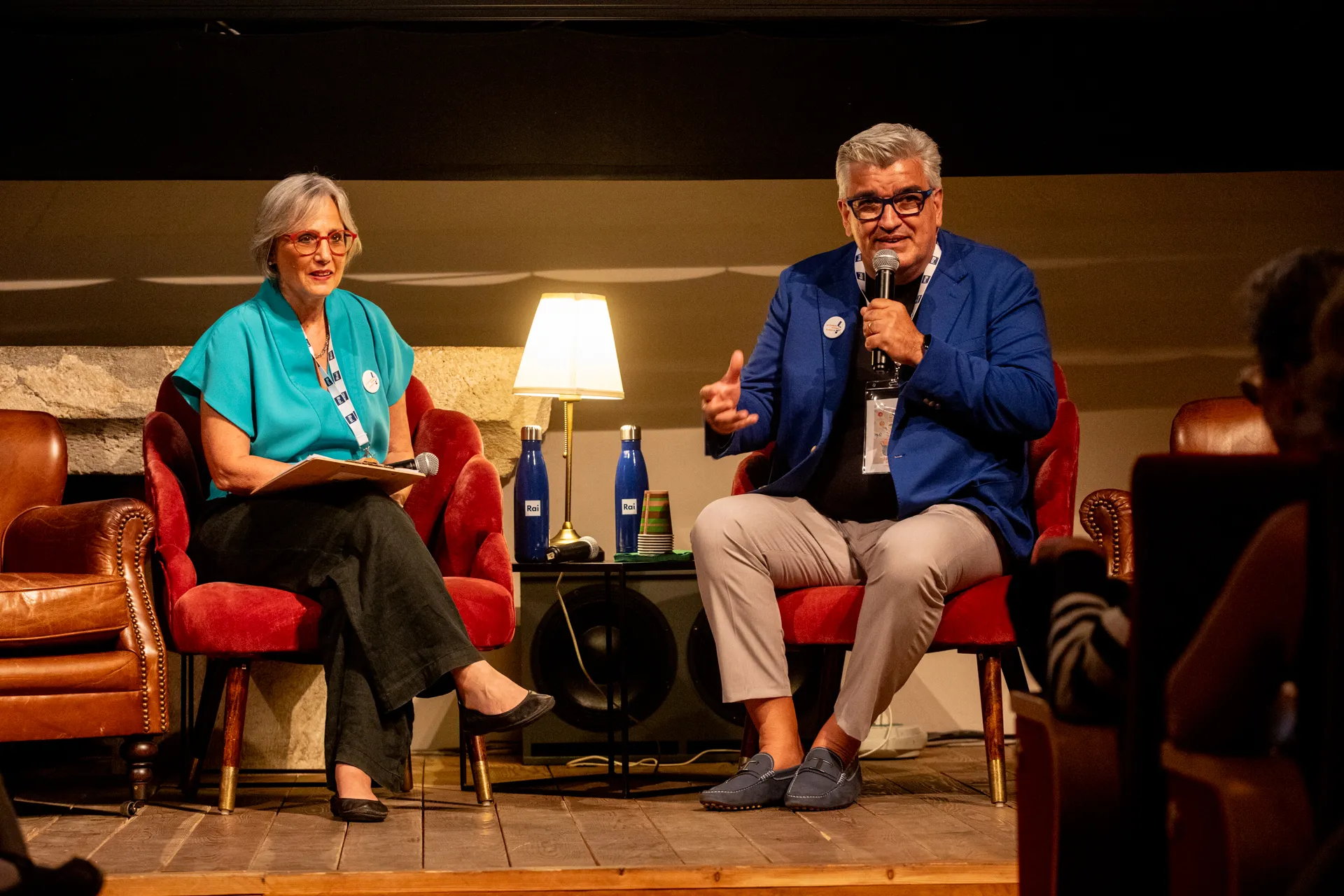 Speakers at Festival di Spoleto engage in conversation on stage with microphones