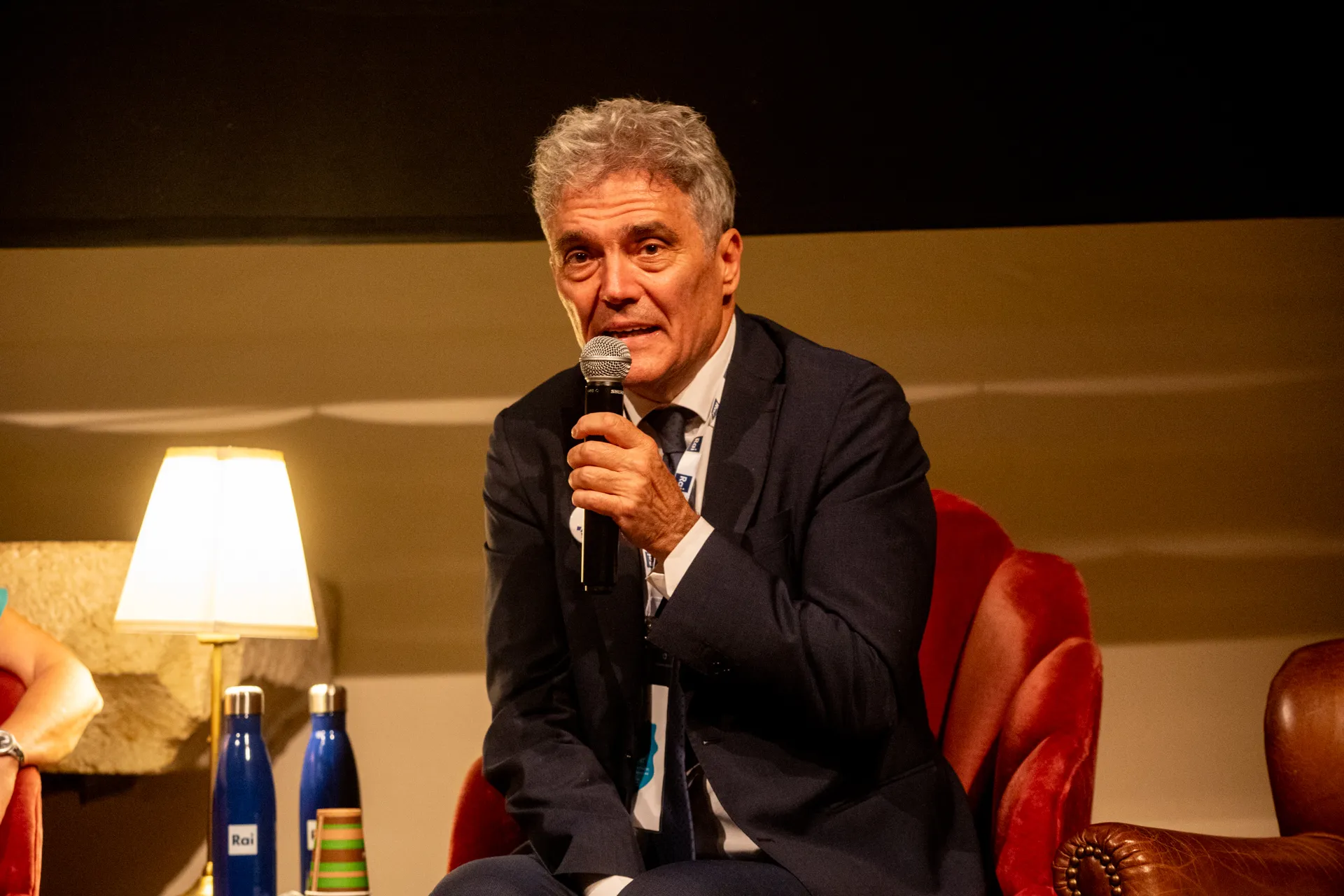 Speaker at Festival di Spoleto panel discussion with microphone