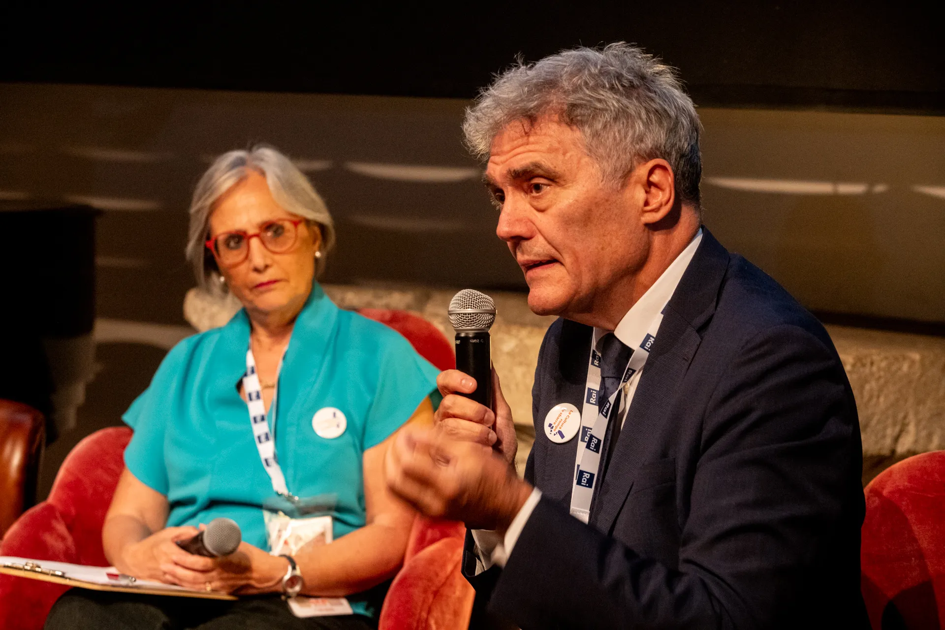 Speakers at Festival di Spoleto panel discussion on stage with microphones