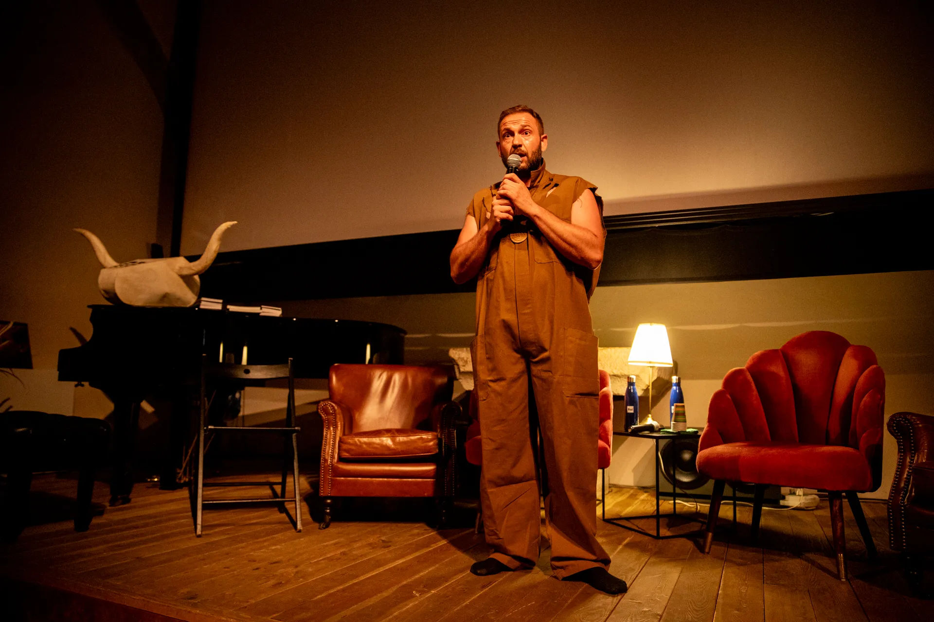Performer on stage at Festival di Spoleto, speaking into microphone