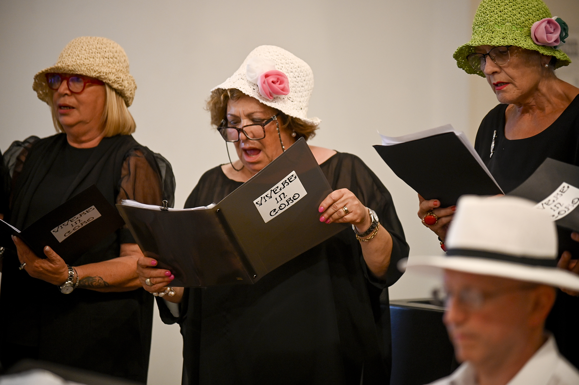 Choir performers in decorative hats at Festival di Spoleto cultural event