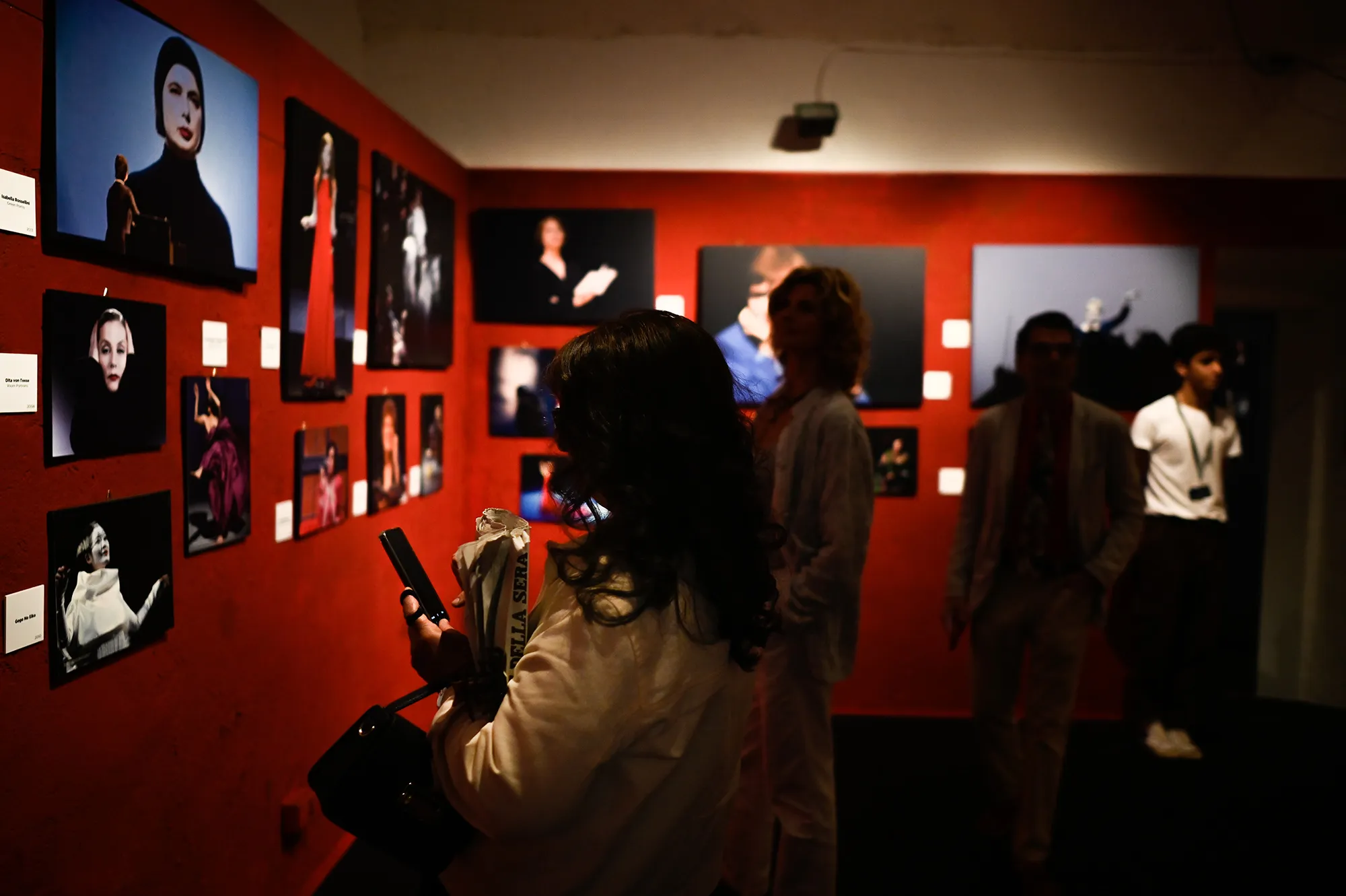 Festival di Spoleto photo exhibition with portraits on vibrant red walls