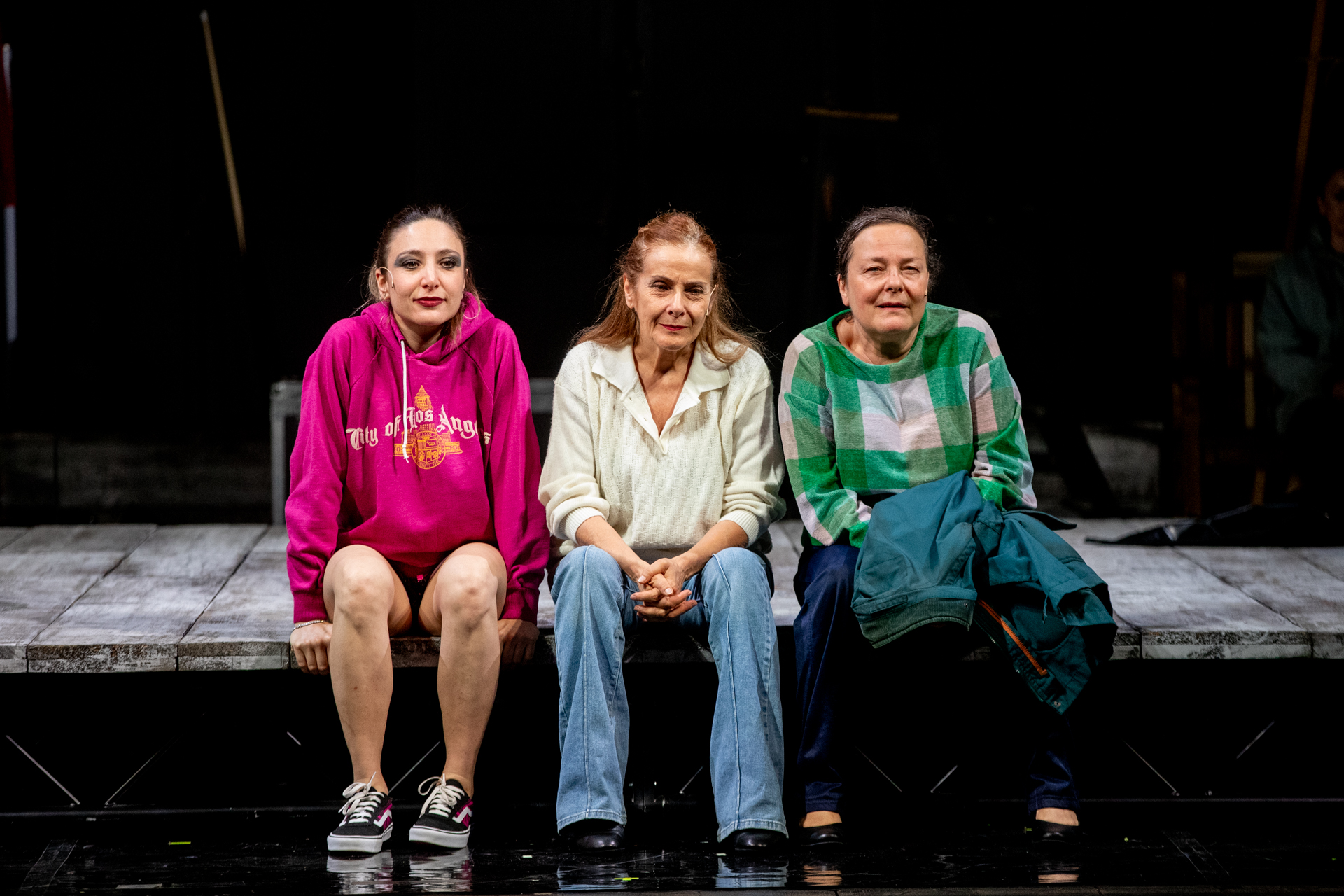 Three women in colorful outfits at Festival di Spoleto performance stage