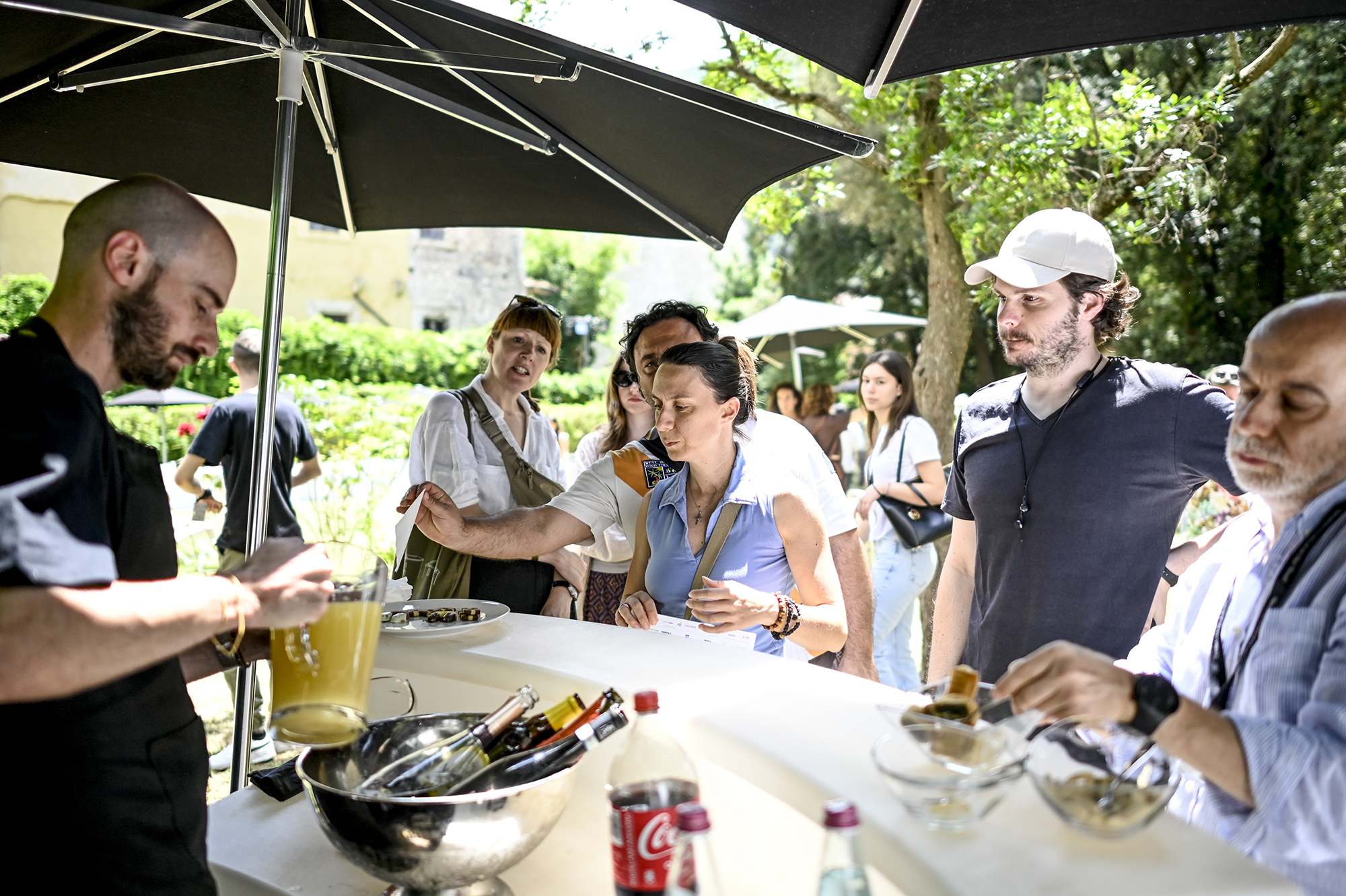 Festival di Spoleto attendees enjoying outdoor culinary event under umbrellas