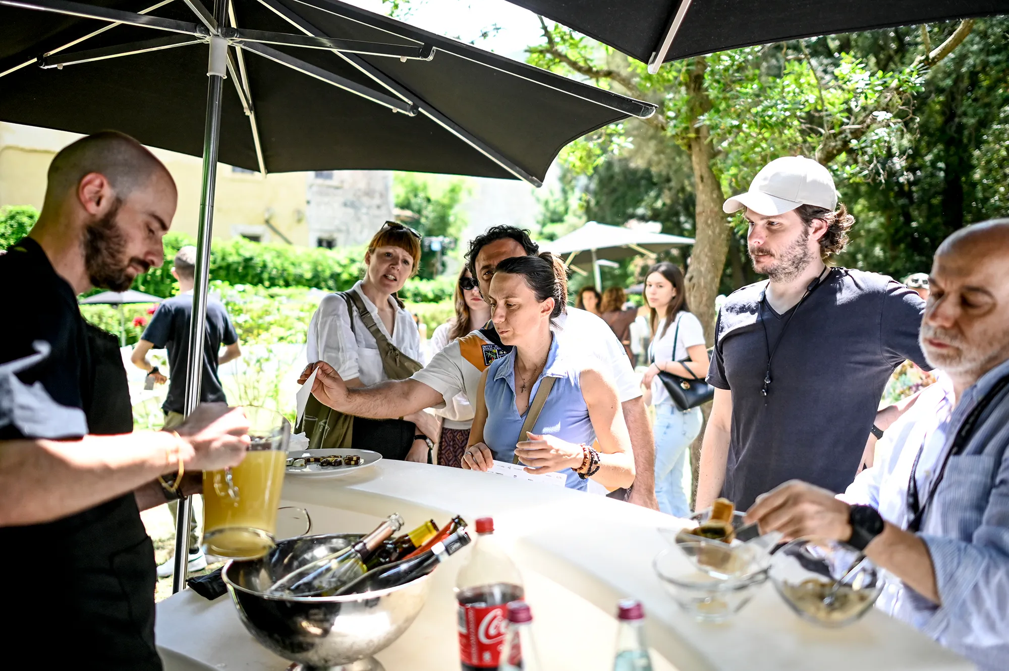 Festival di Spoleto attendees enjoying outdoor culinary event under umbrellas
