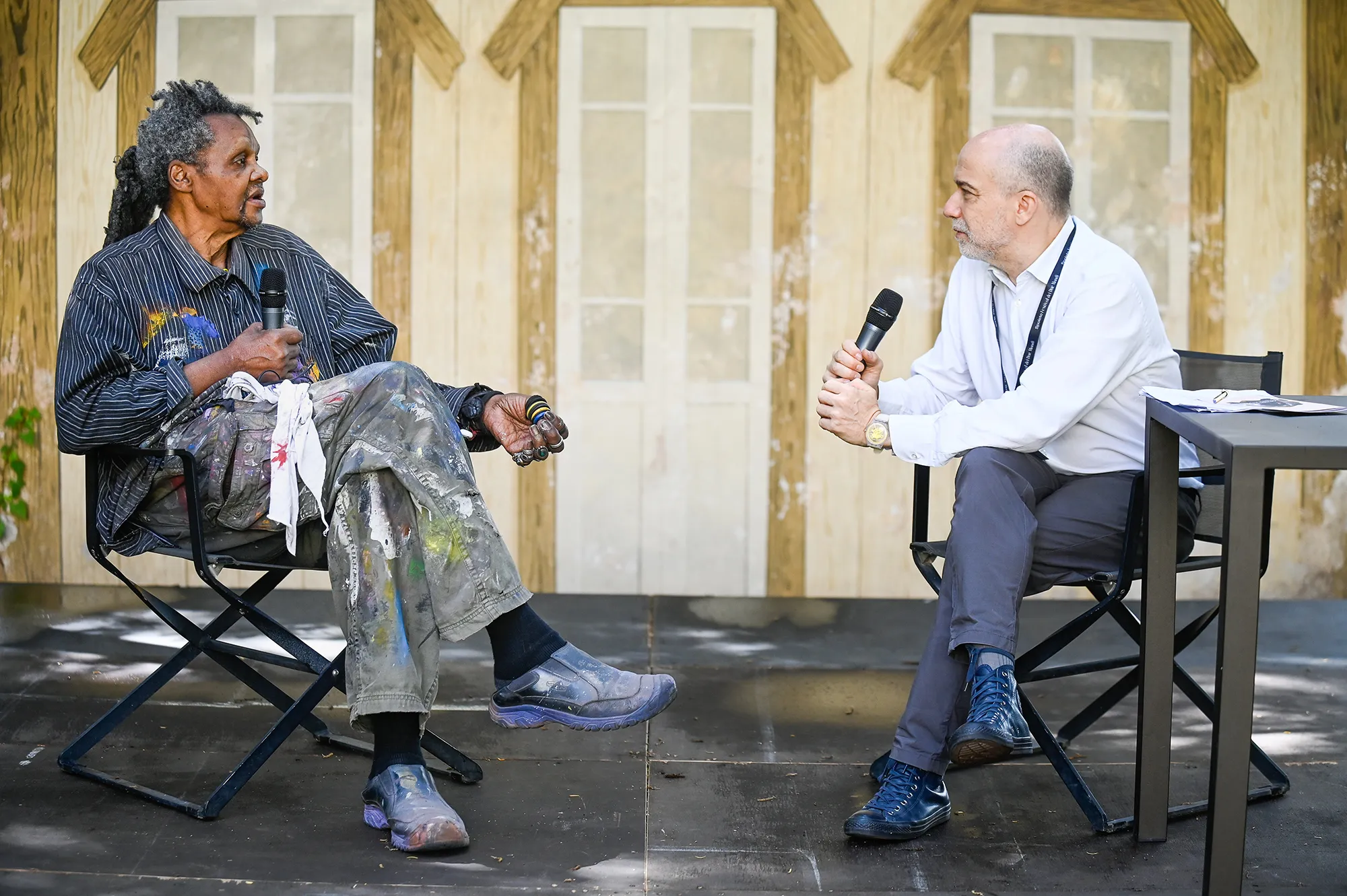 Festival di Spoleto panel discussion with two speakers holding microphones