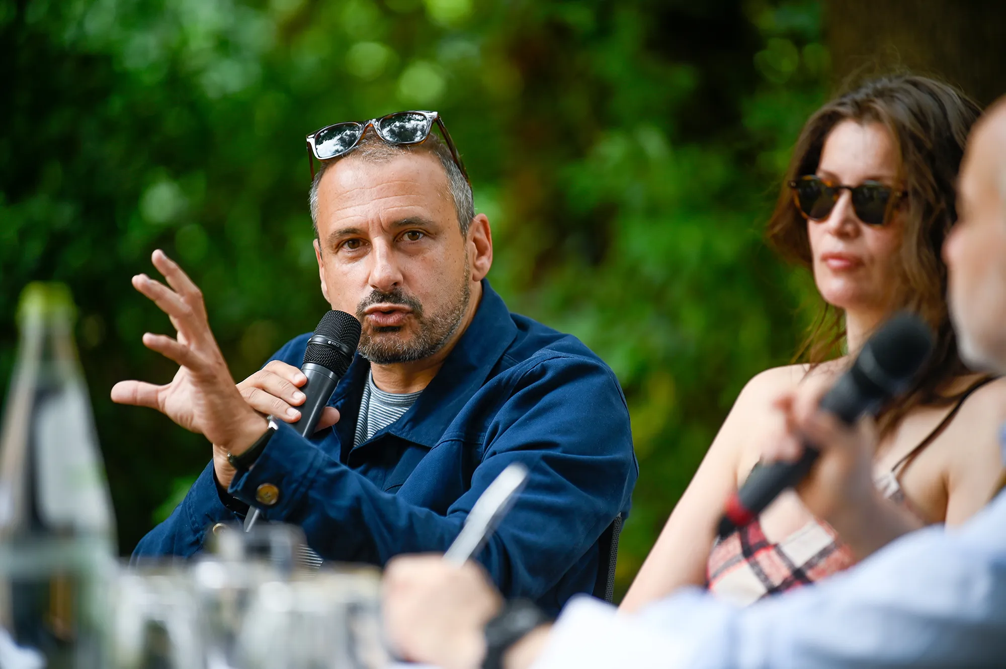 Speaker discussing creativity at Festival di Spoleto press conference outdoors