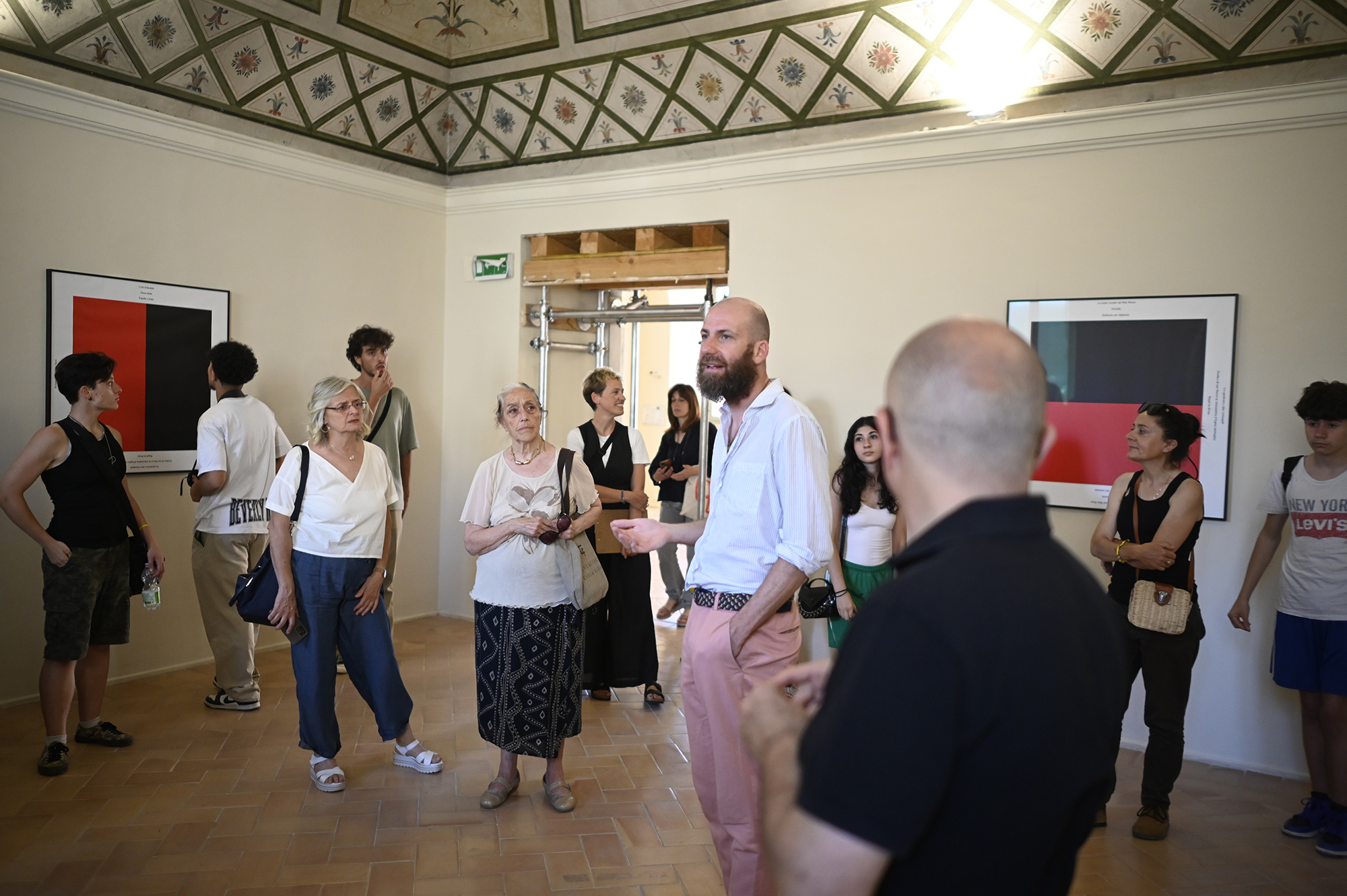 Festival di Spoleto exhibition visitors explore art gallery with red paintings