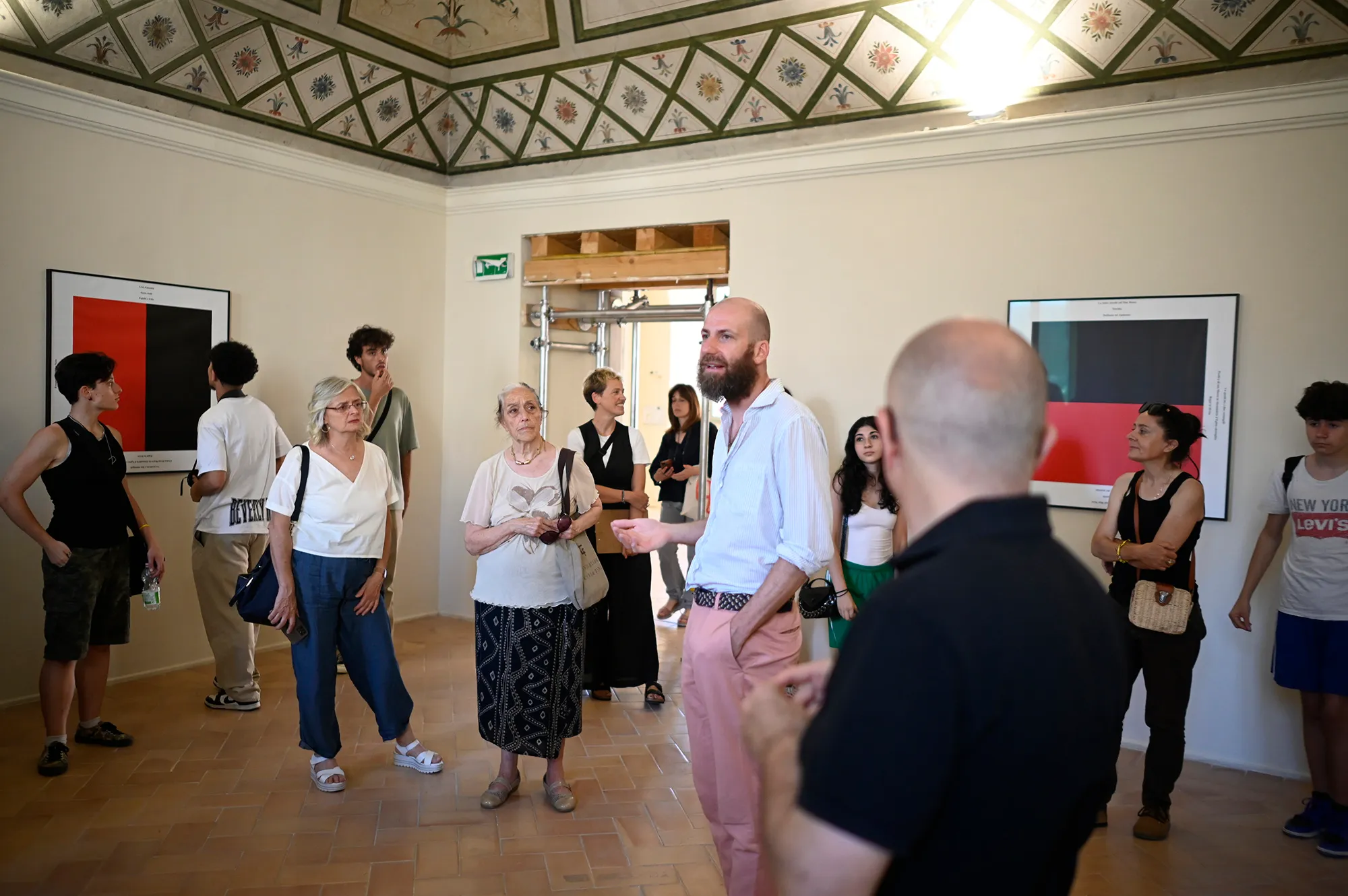 Festival di Spoleto exhibition visitors explore art gallery with red paintings