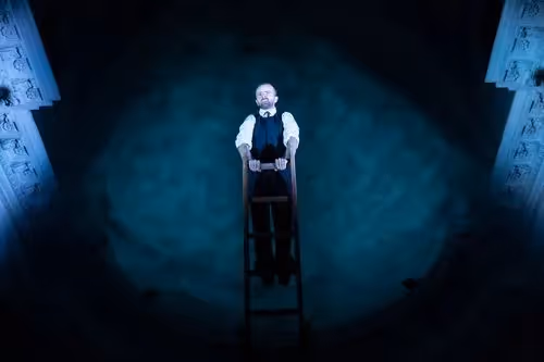 Performer standing on ladder at Festival di Spoleto theatrical performance