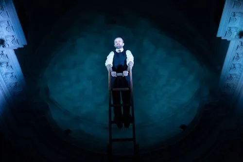 Performer standing on ladder at Festival di Spoleto theatrical performance