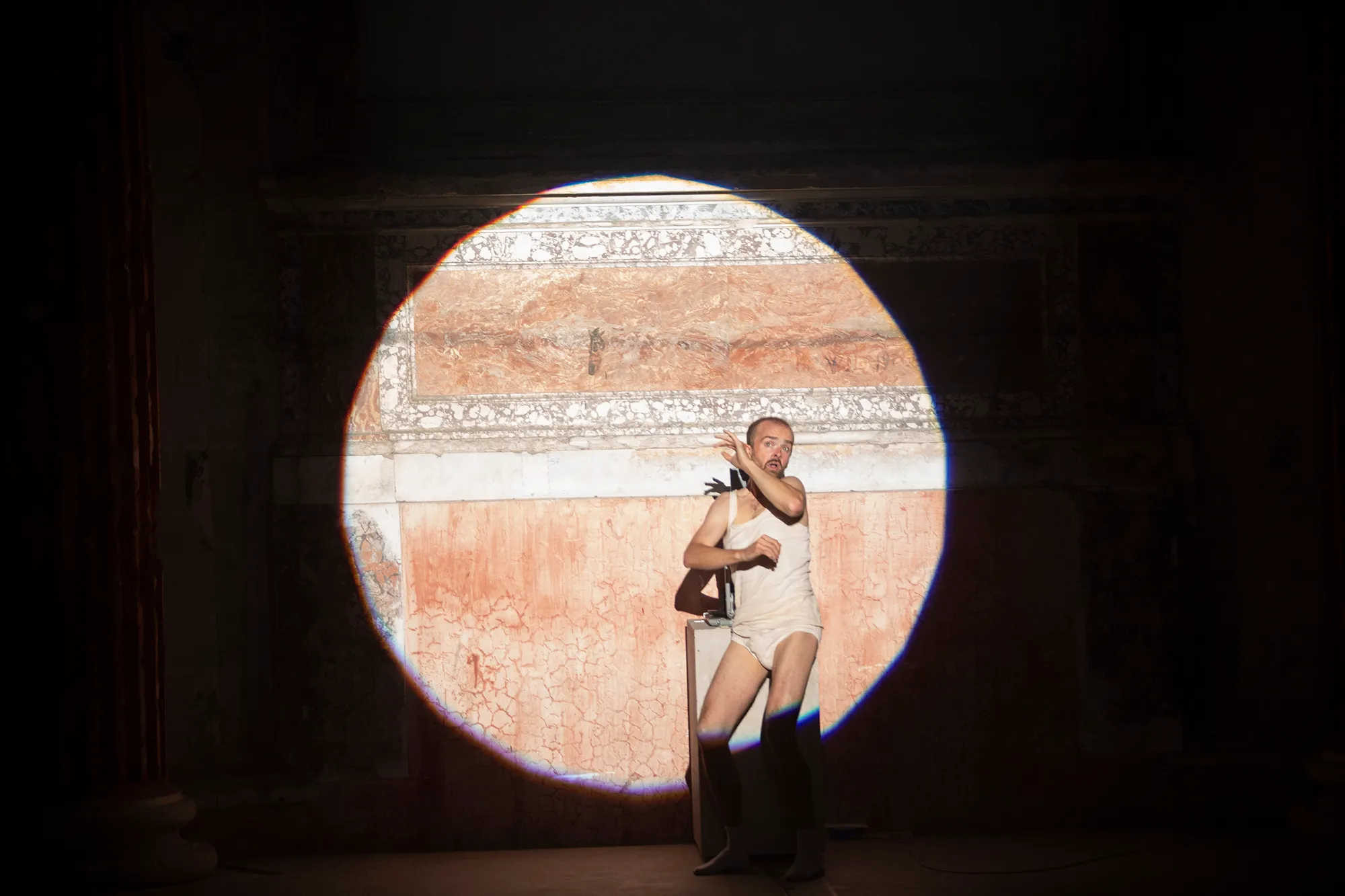 Performance artist at Festival di Spoleto framed by dramatic circular spotlight