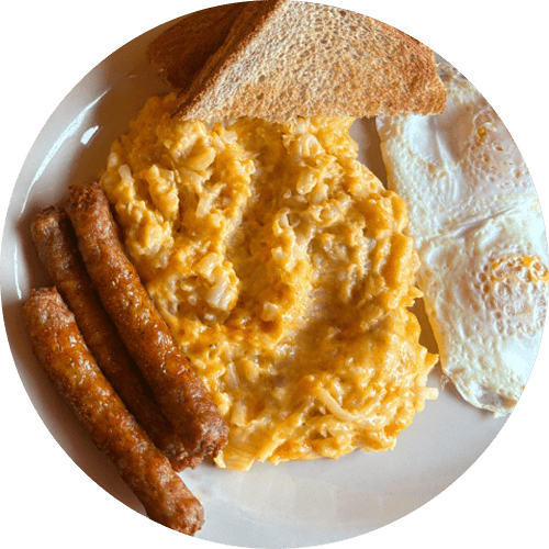 Breakfast plate with scrambled eggs, fried eggs, three sausage links, and a slice of toasted bread.