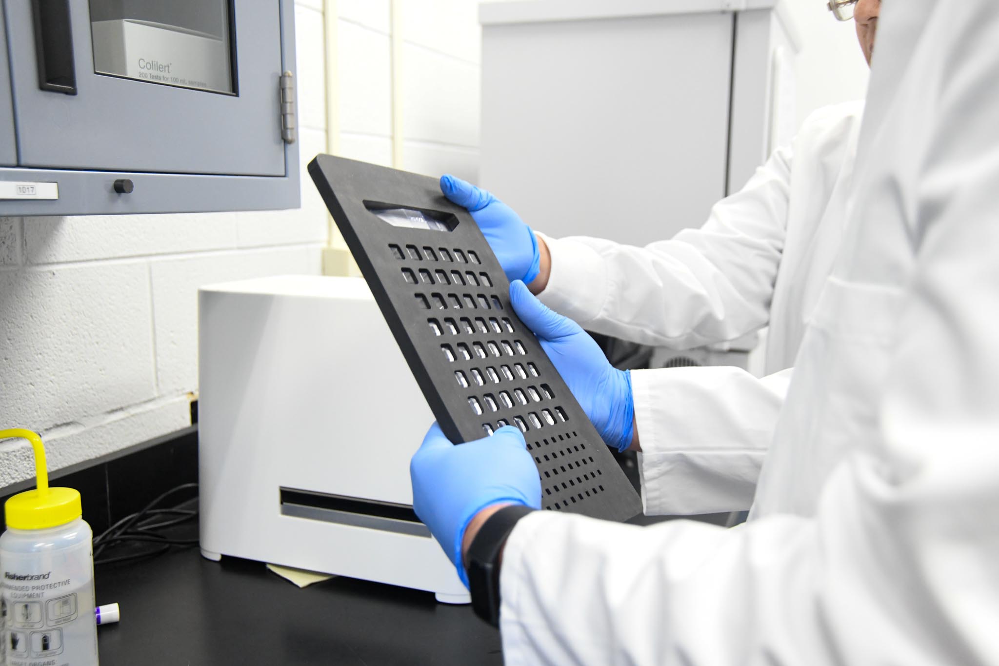 two lab workers going over results of water testing in a lab eniroment