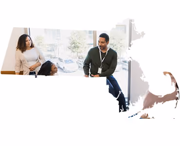 Instructor speaking to students near a window, Massachusetts