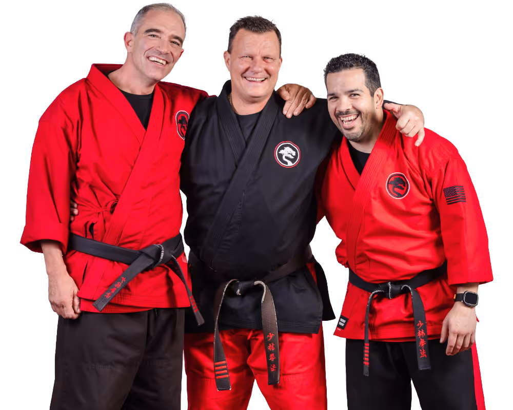 A casual professional standing in front of a building holding a generic tablet.