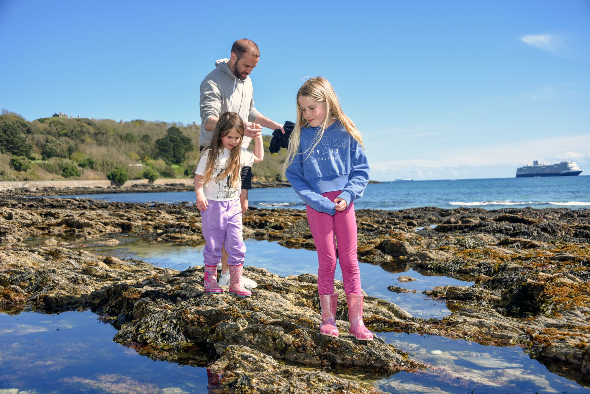 Family exploring rock pools