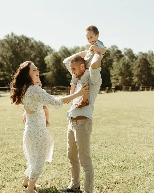 Taylor and Jacob playing with their kids in an open field and showcasing the family-first and people-first values behind their done for you bookkeeping services.