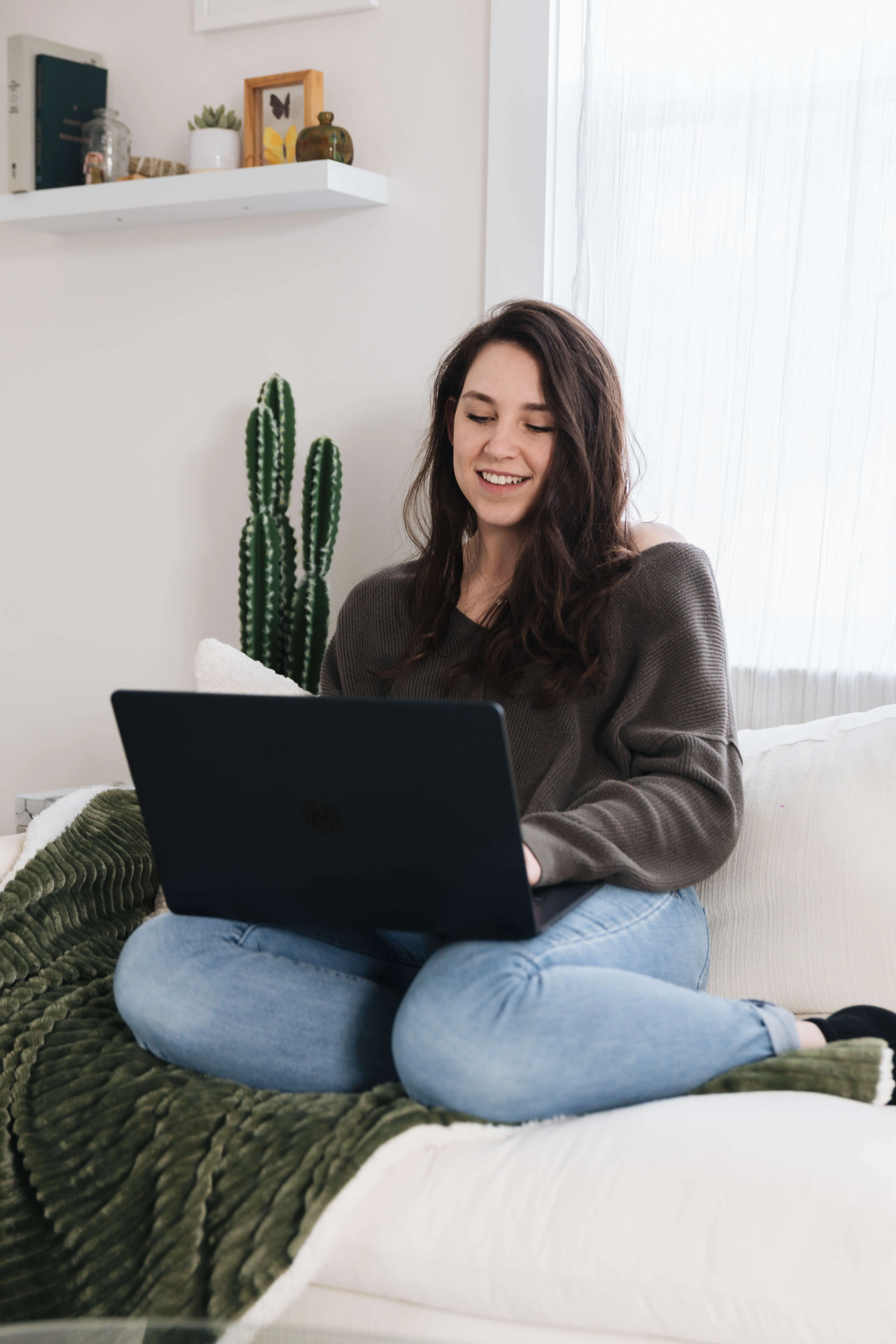 Taylor sitting in front of her laptop, smiling at the screen