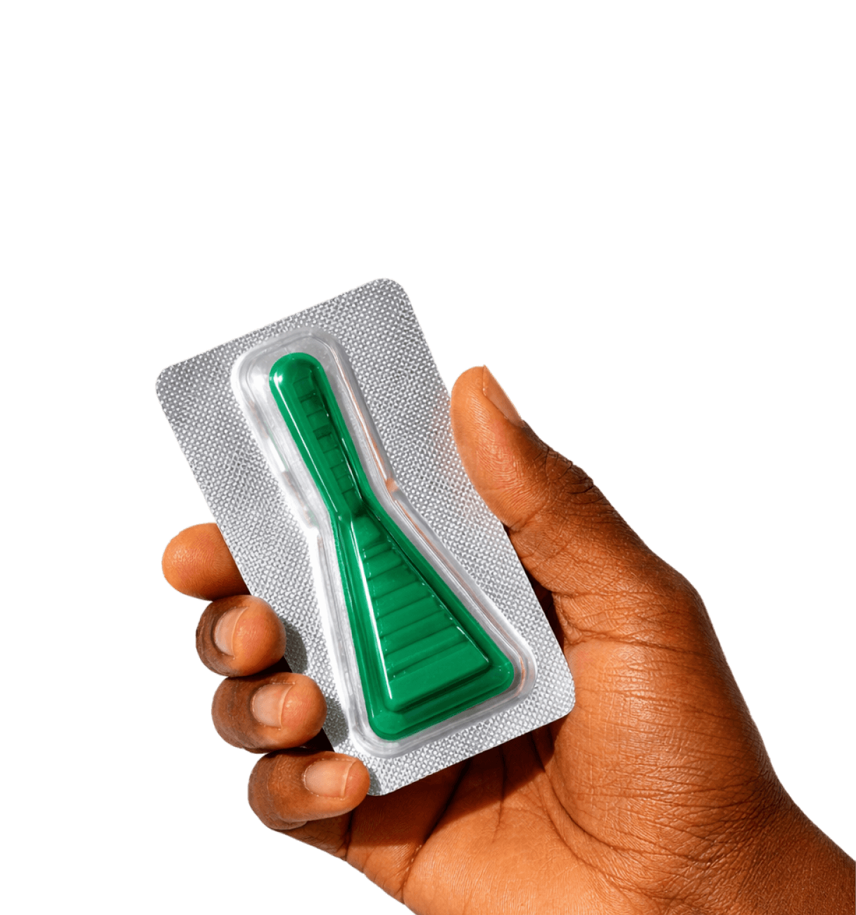Hand holding a sealed silver blister pack containing a green plastic tool with a tapered shape.