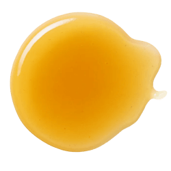 Golden, glossy rice malt syrup with a thick, smooth texture spread in a small puddle on a white background