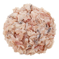Finely chopped silver hake fish with pale pink and white flakes and a soft, moist texture, ideal for dog food ingredients