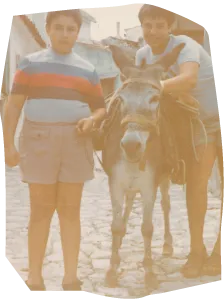 an old photo of two boys and a donkey