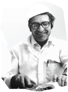 an old photo of a man serving yiros