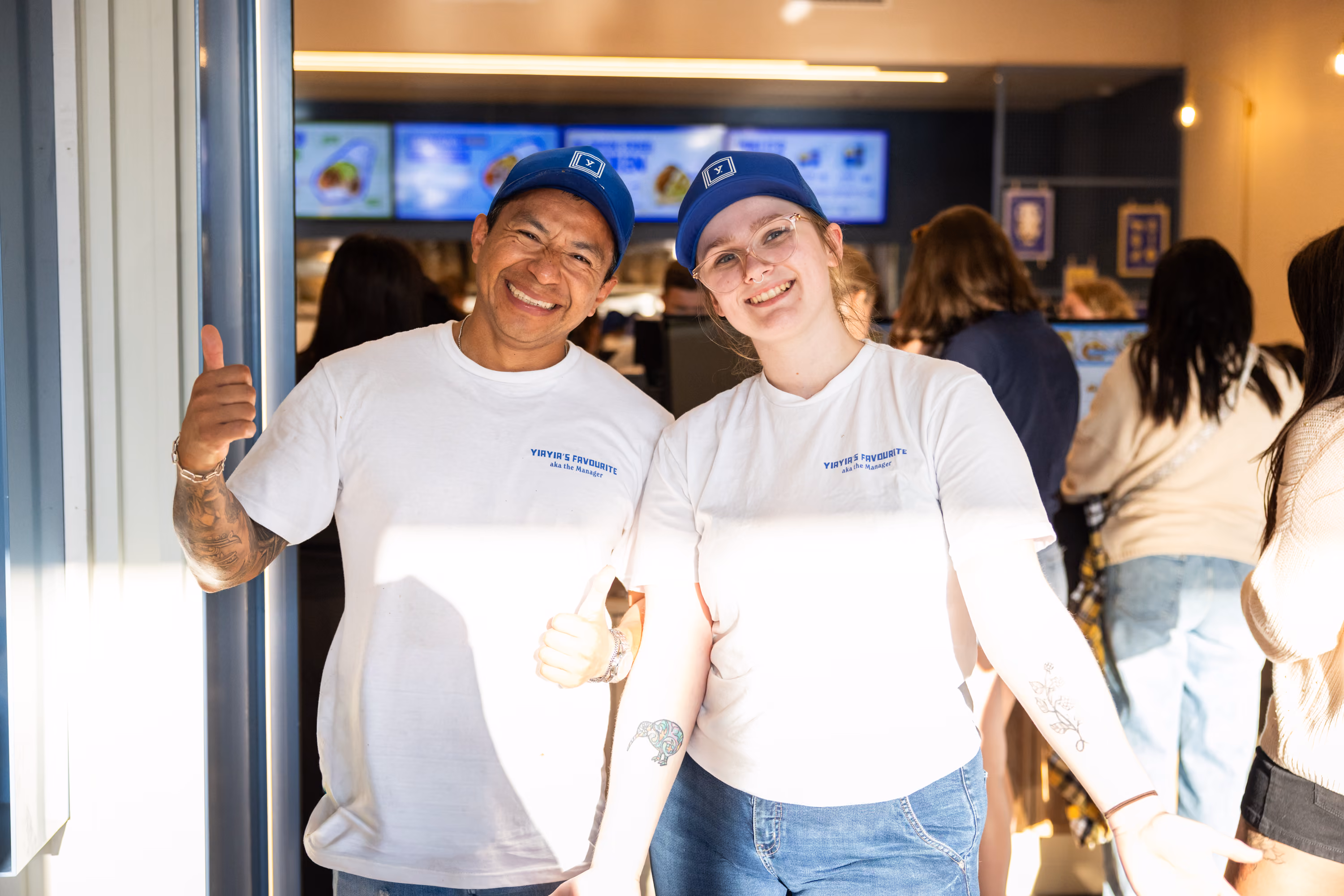 Two smiling restaurant managers at The Yiros Shop