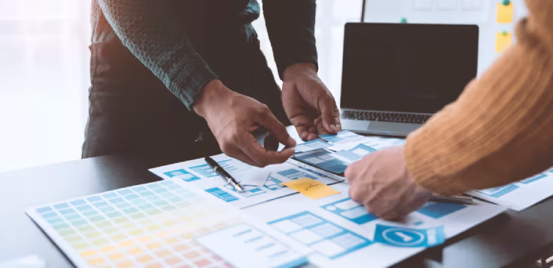 Two team members brainstorming on a design project, highlighting NetSuite optimization services and their associated benefits.