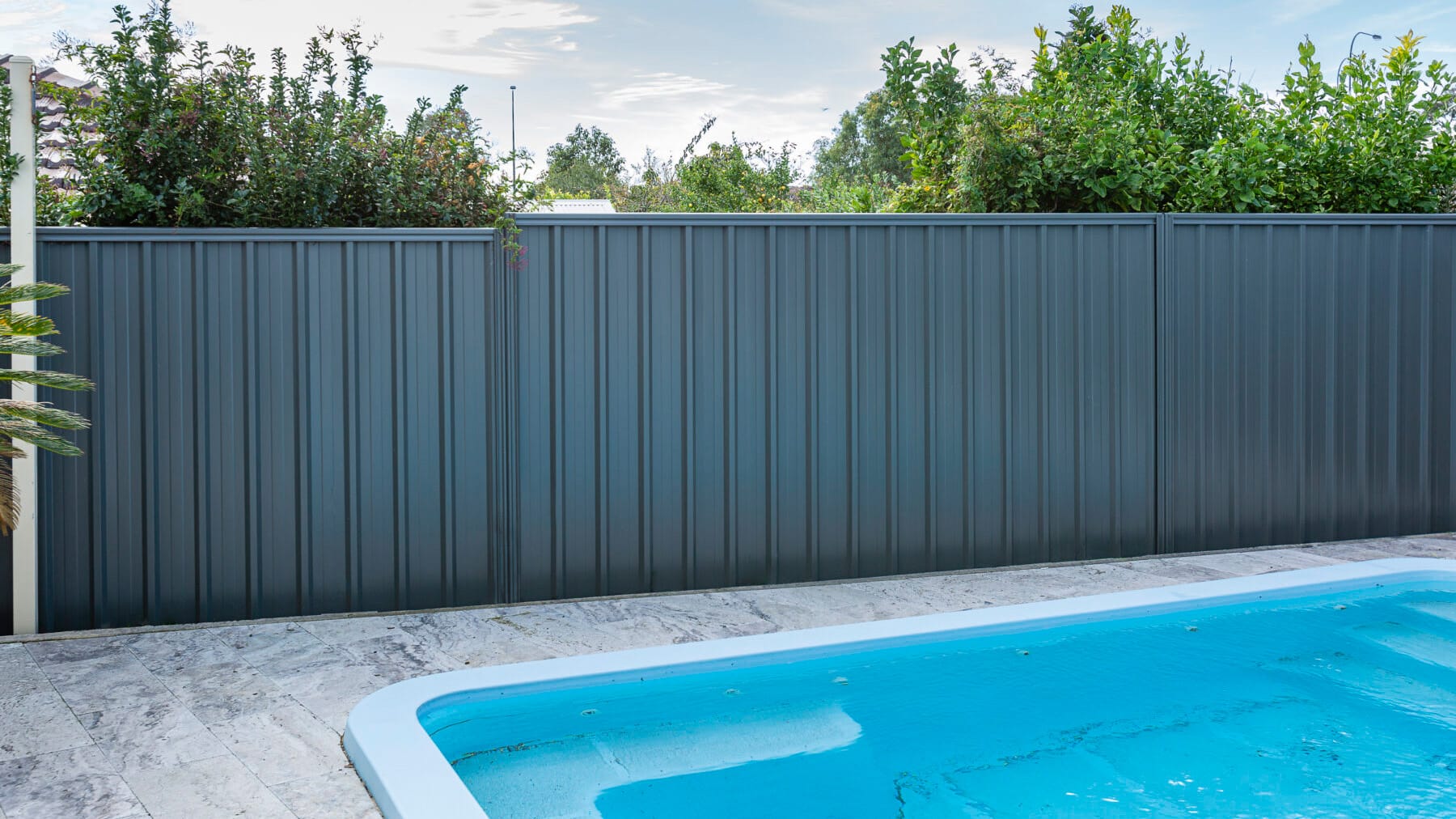 Dark gray Colorbond steel fence with vertical corrugated