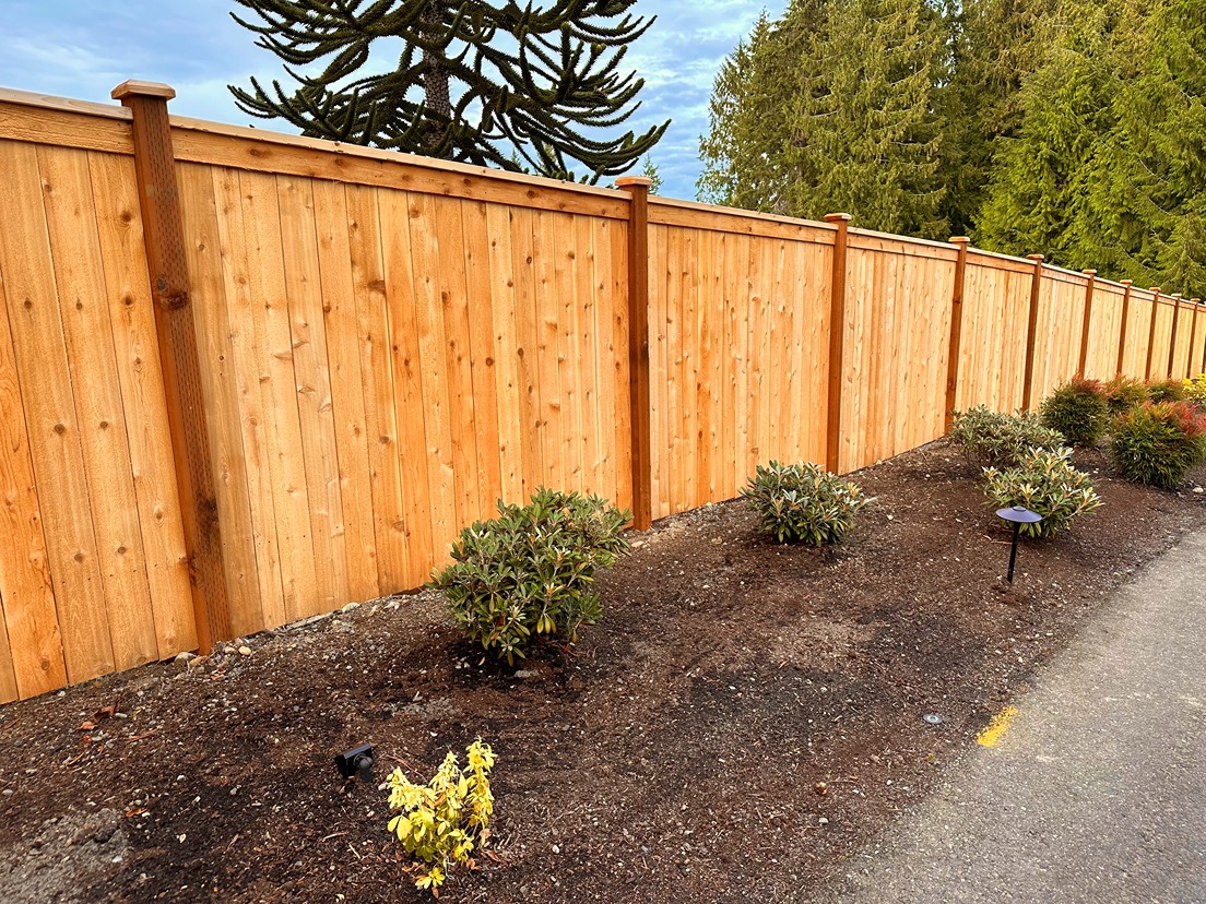 Cedar modified full panel fence installation along a residential property line