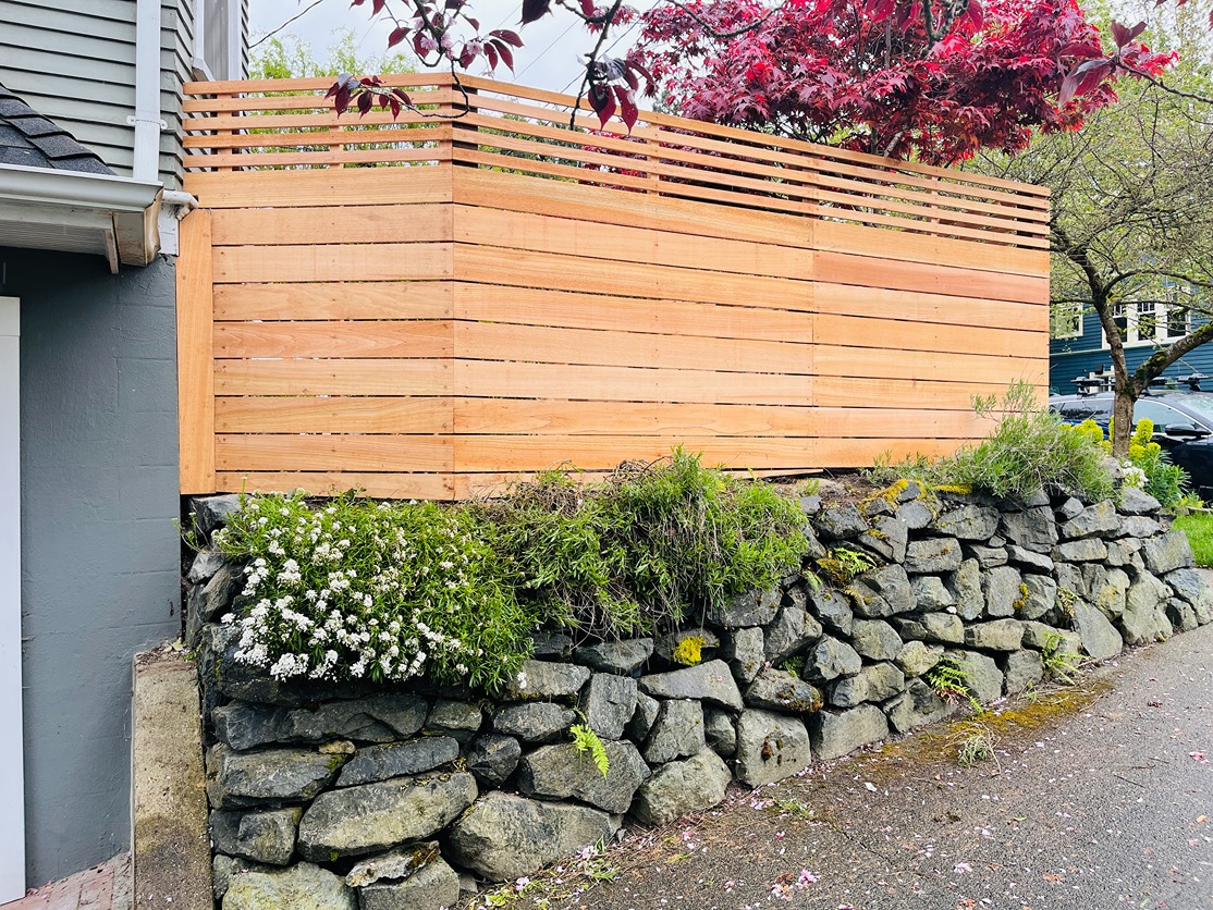 Horizontal wood fence with open slat top