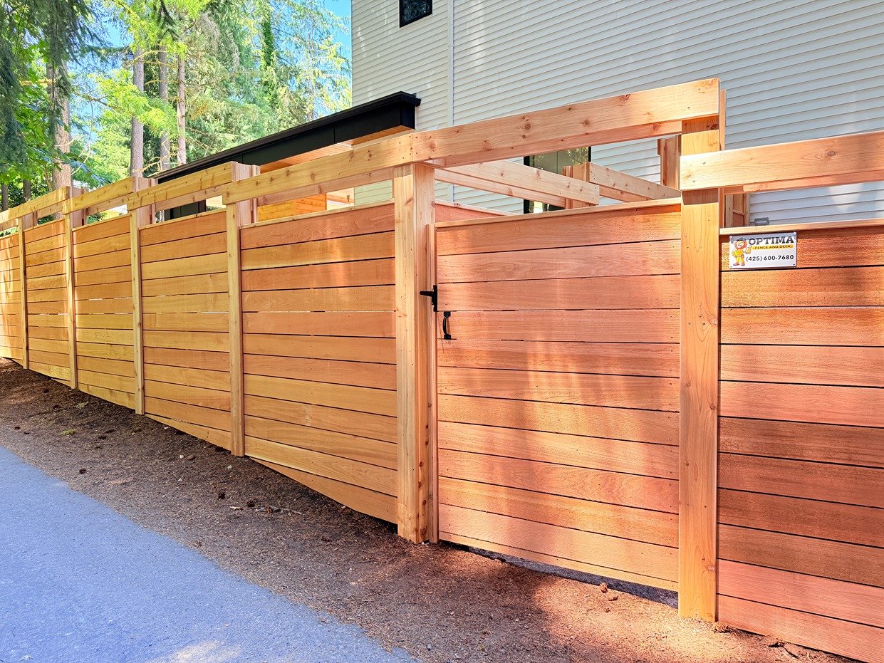 Modern horizontal wood fence with wide cedar boards and matching gate