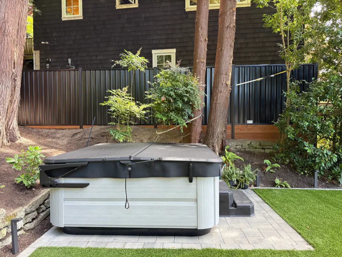 Weather-resistant ColorMax metal fence installed along side yard of a contemporary house.