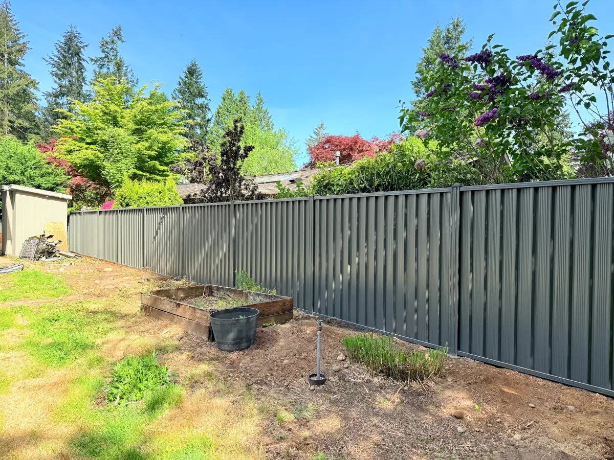 Durable steel privacy fence bordering Bellevue home’s exterior landscaping.
