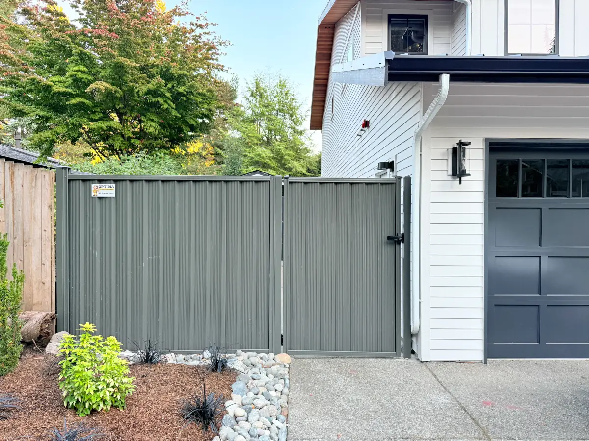 Modern gray ColorMax metal fence providing privacy around landscaped Bellevue yard.