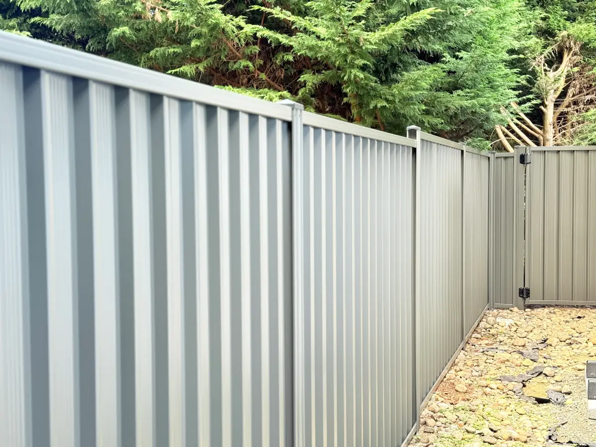 Secure and low-maintenance ColorMax metal fence surrounding side exterior of suburban home