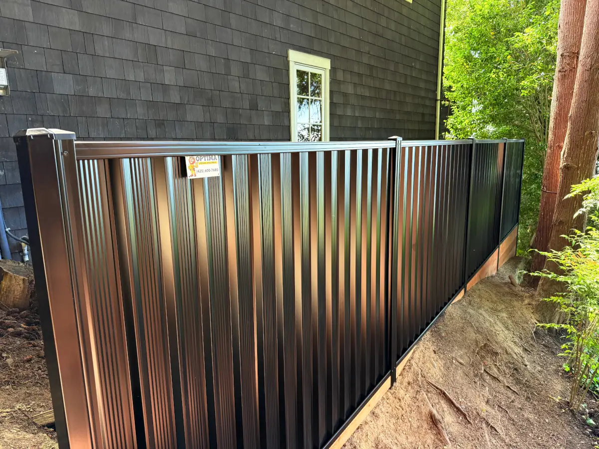 ColorMax black metal fence providing durable privacy in a shaded outdoor relaxation space