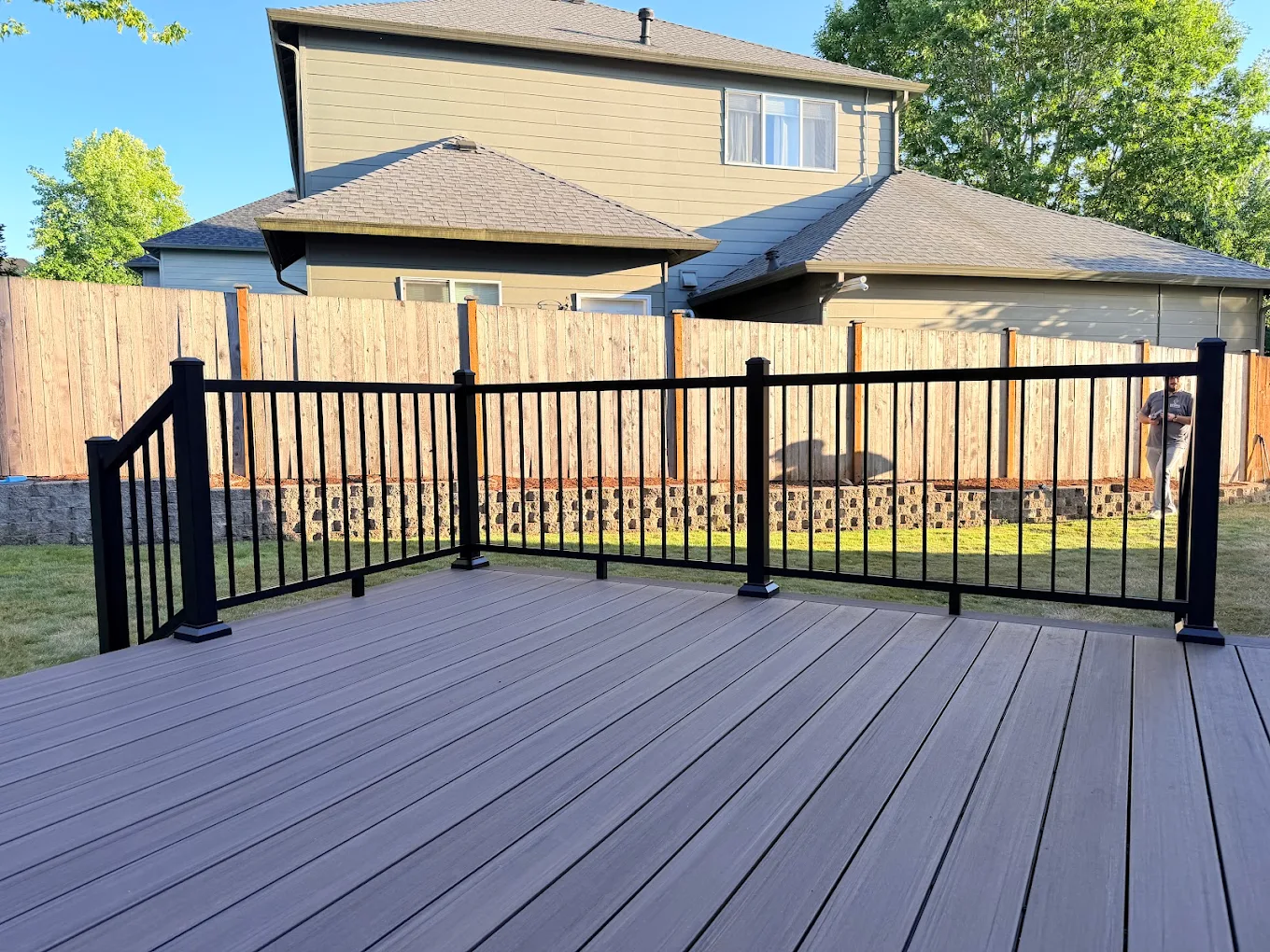 Semi-transparent stain application on a residential backyard wood deck in Bellevue