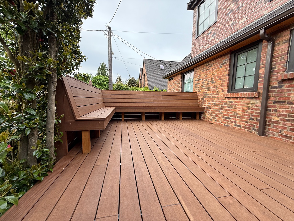 Restored wood deck in a Bellevue backyard with wooden bench overlooking a Bellevue neighborhood