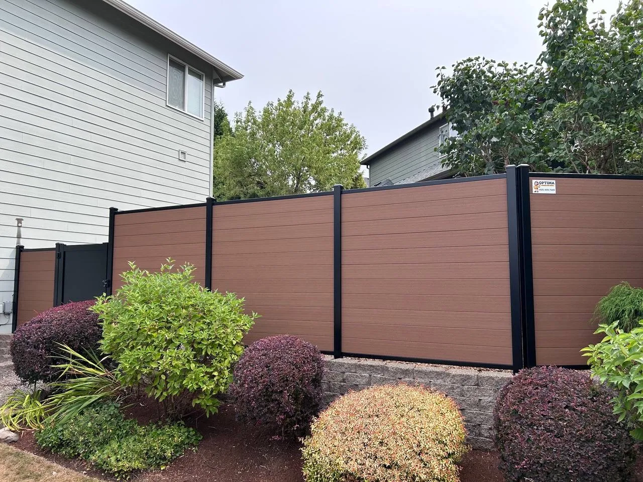 Full privacy composite fence with shrubs in Bellevue
