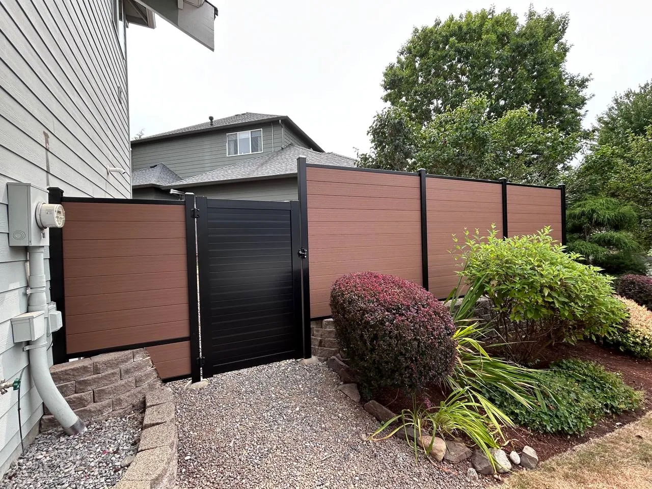 Composite privacy fence and gate near a driveway in Bellevue