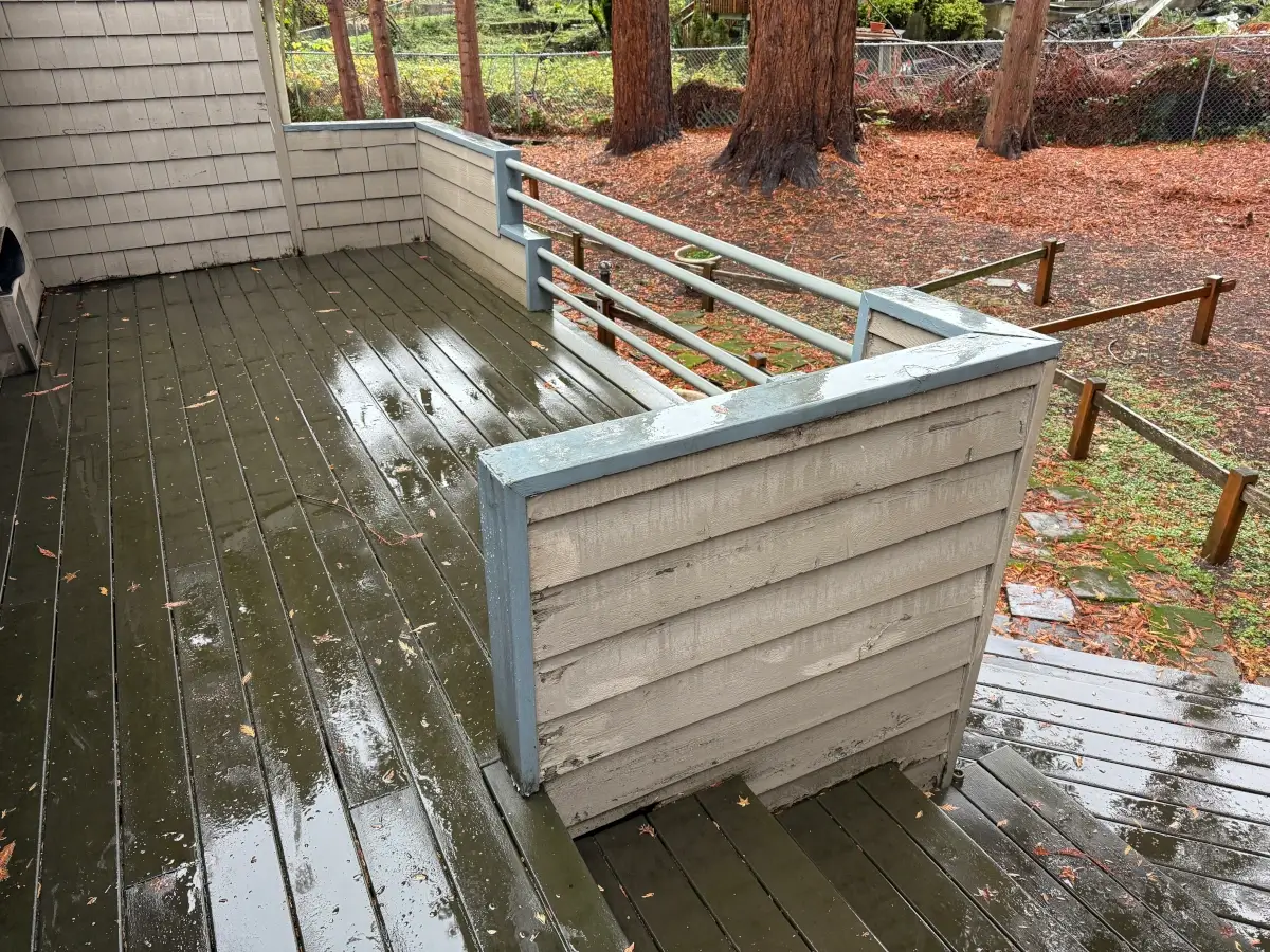 Old wooden deck with weathered boards and deteriorating railing