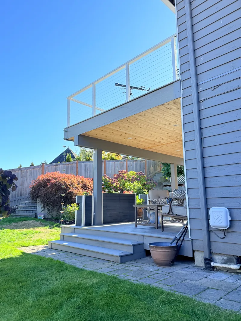 Two-level residential deck construction on a Tacoma home using composite materials and aluminum railing.