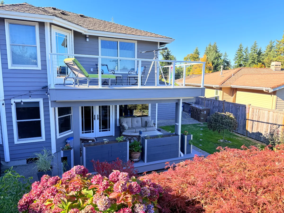 Exterior view of a Tacoma residence featuring a newly built two-story deck connected to both levels of the home