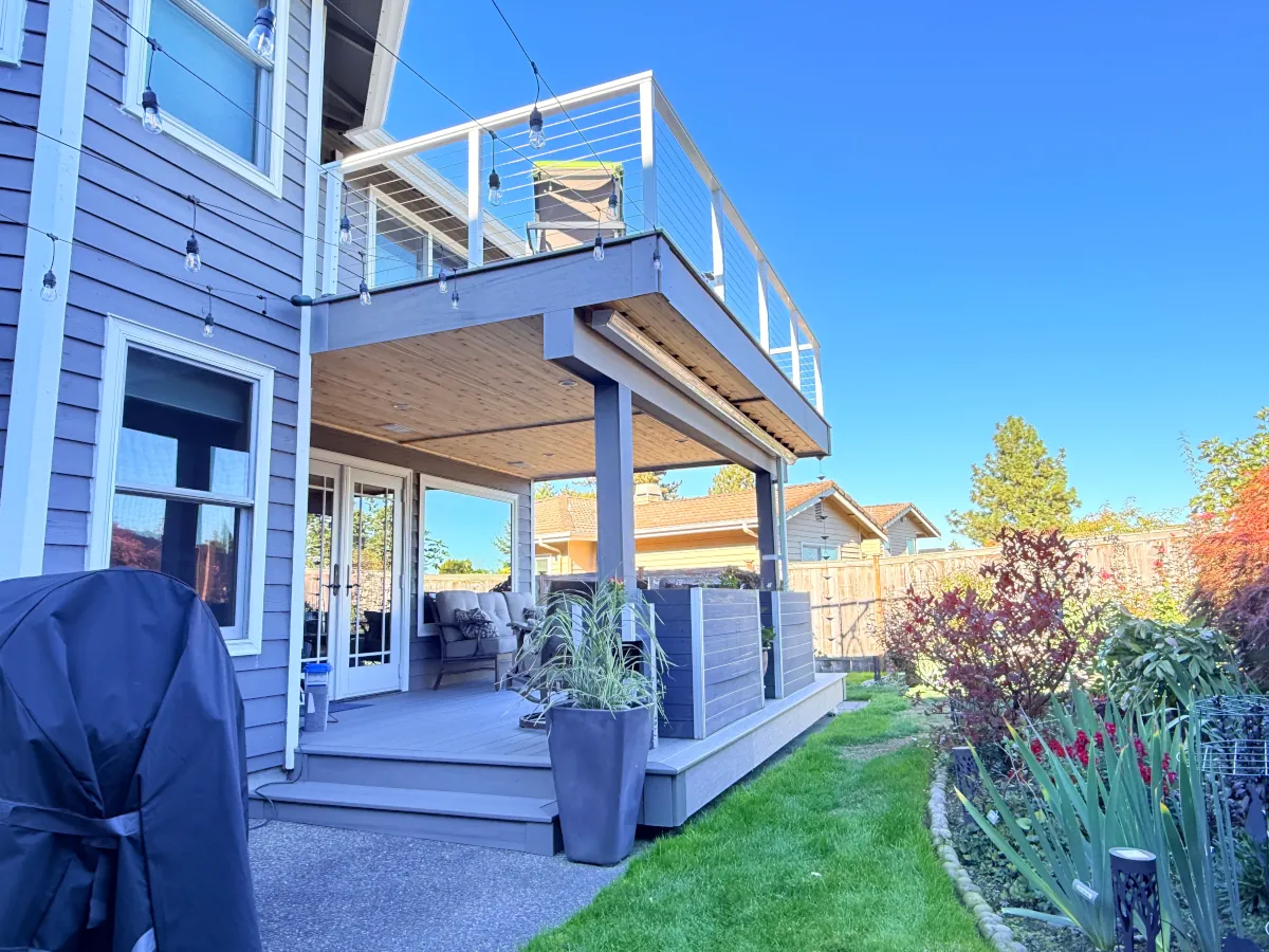 Detailed view of a Tacoma deck featuring composite decking, cable railing, and a waterproof lower level.