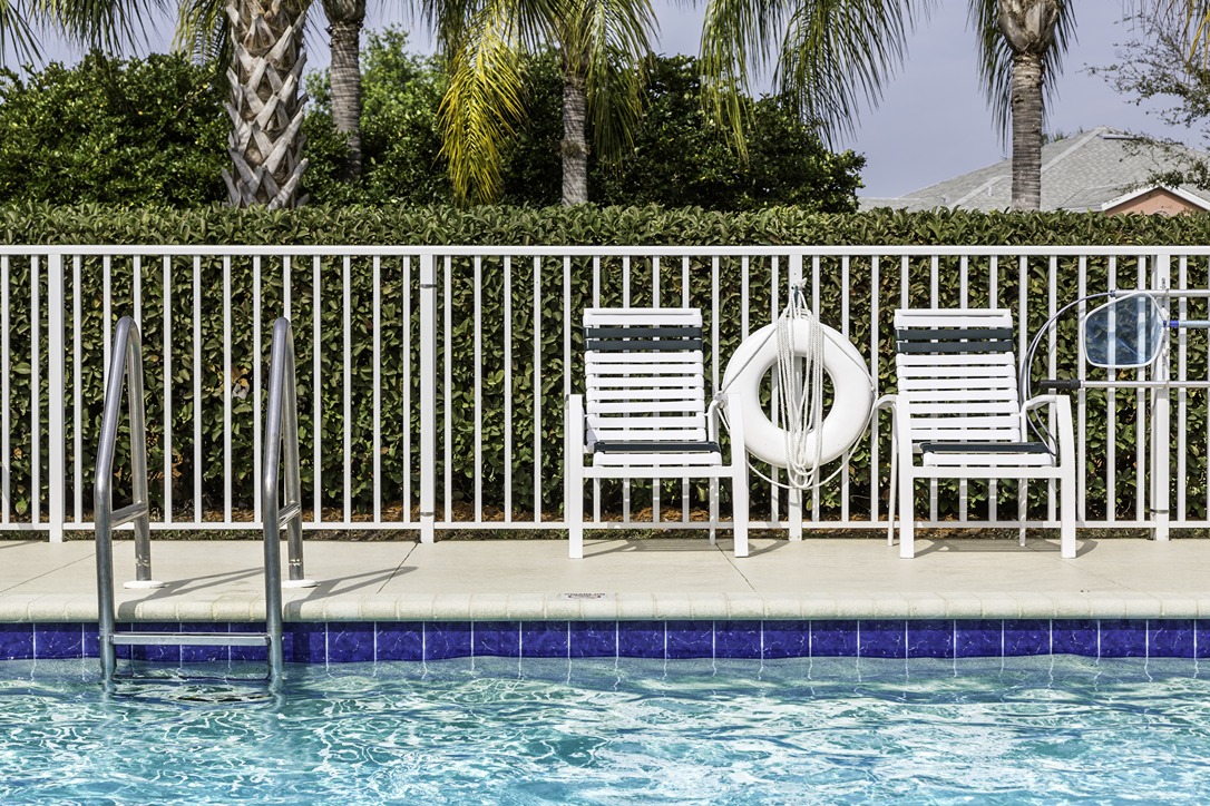 Compliant pool safety fence surrounding a residential swimming pool