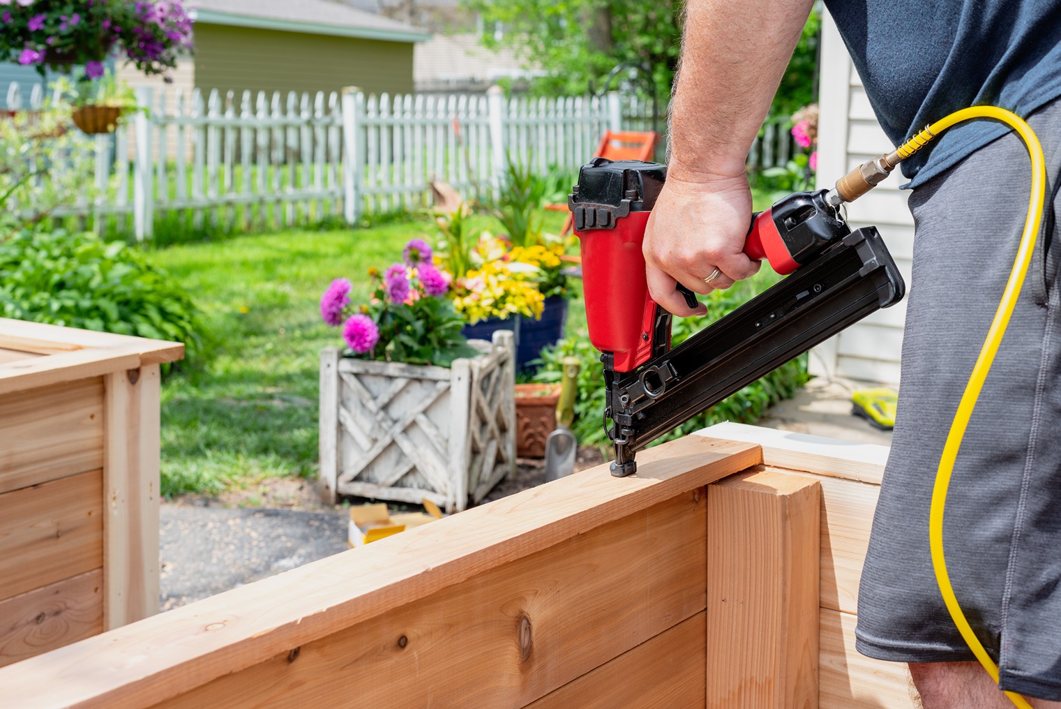Contractor building a wood privacy fence in a residential backyard