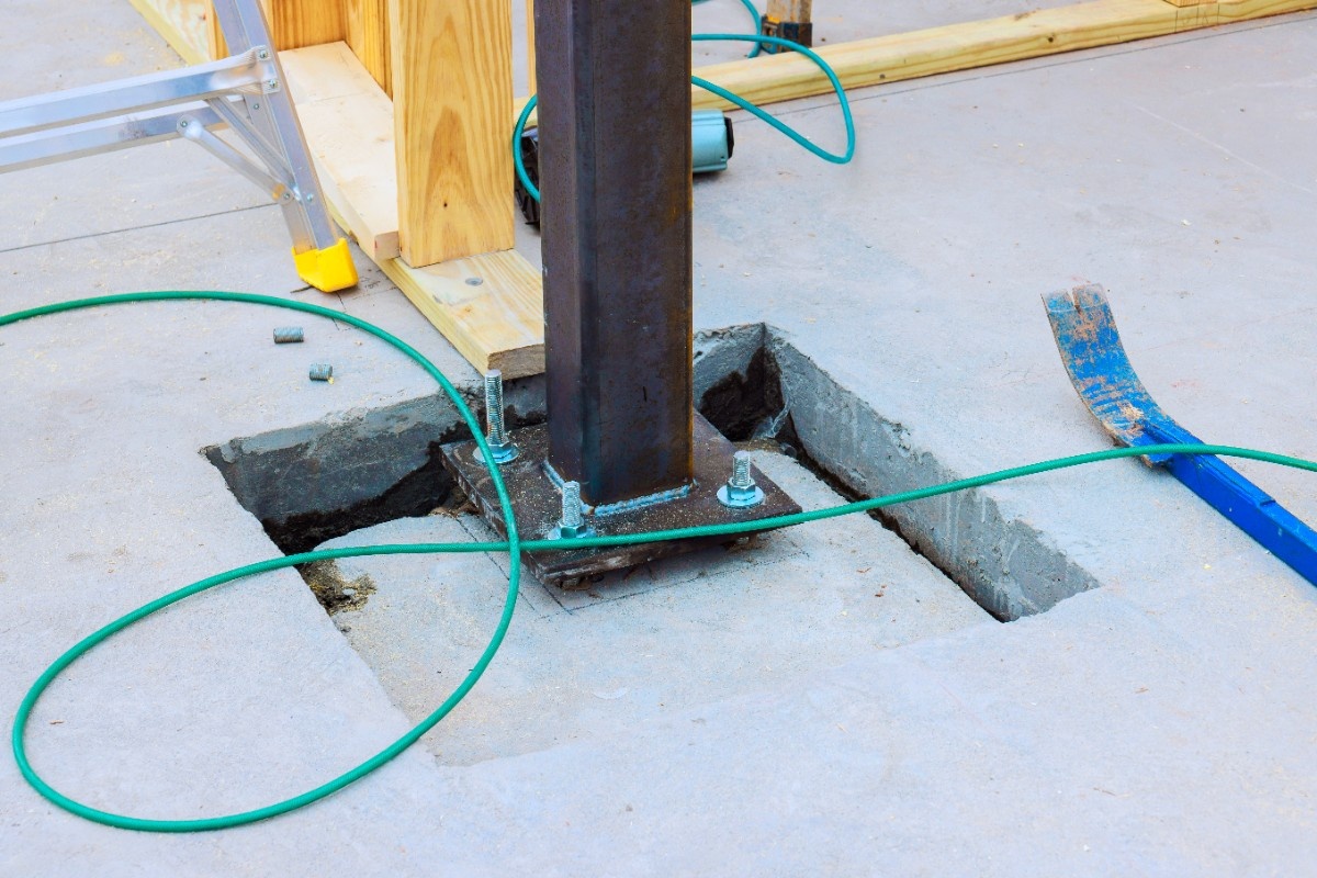Cedar post attached above a galvanized steel pipe fence post